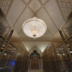 Elegant interior featuring a grand chandelier and intricate design, exuding luxury and grandeur.