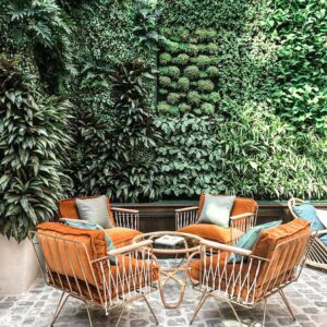 Charming outdoor patio featuring lush vertical garden and elegant seating, offering a tranquil retreat.